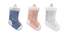 Close-up of glittery blue, pink, and silver plastic Christmas stocking hanging ornaments