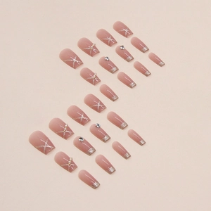 Short ballet press-on nails with nude pink base, glitter gradients, and pearl diamond accents