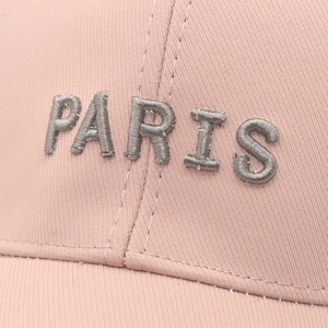 Detail of light pink baseball cap featuring 3D silver PARIS embroidery with fine stitching