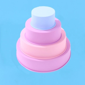 Macro view of four stacked round silicone cake molds in vibrant pastel gradient colors