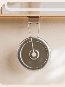Detail of silver magnetic toothbrush holder mounted on marble wall with LED lighting