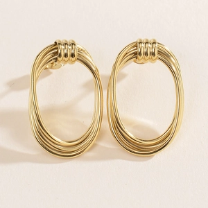 Detailed macro view of 14K gold plated stainless steel multi-layered oval hoop earrings