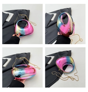 Detail view of iridescent candy-colored hardshell bag with gold chain and round handle