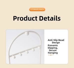 Detail view showing non-slip ball hooks on white metal jewelry storage rack