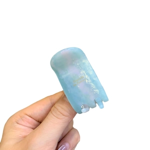 Iridescent light blue acetate flower hair claw clip with pearlescent texture for high ponytail