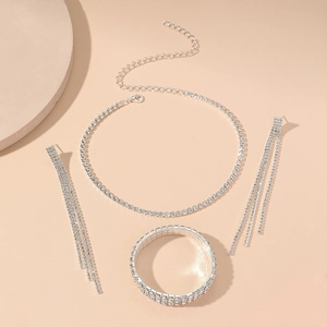 Detail of silver rhinestone jewelry set including choker necklace, bracelet and earrings