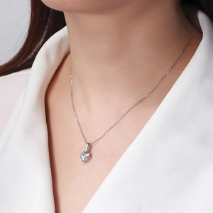 Gros plan d'un élégant collier cœur en argent s925 avec un zircon brillant sur un mannequin