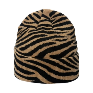 Detail of soft knit beanie texture with warm black and brown striped pattern
