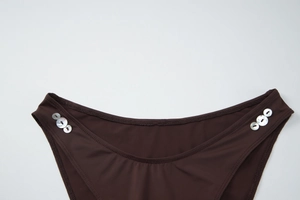 Detailed close-up of dark brown bikini bottoms with white decorative shell buttons