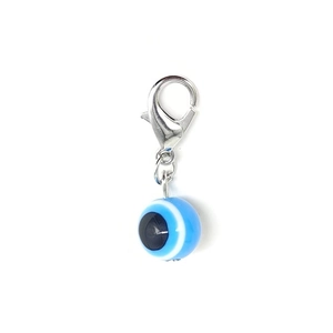 Detailed view of evil eye resin bead charm with a silver lobster clasp for DIY jewelry