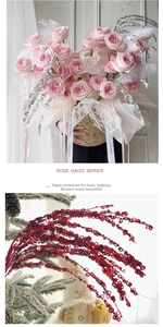 Detail of pink silk roses and red sequin firework branches for DIY holiday floral decor