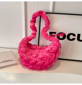 Detail of pink velvet quilted cloud bag with soft 3D stitching texture and handle