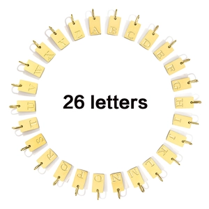 Detailed flat lay of twenty-six gold plated stainless steel letter charms for DIY jewelry