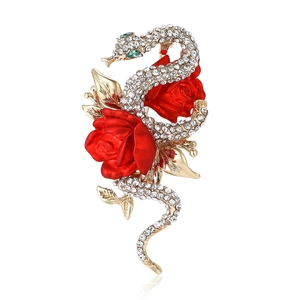 Luxury gold brooch featuring a snake wrapped around a red enamel rose with crystals