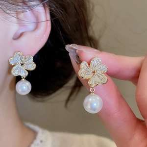 Detail of floral earring with micro-set zircon petals and a round white pearl