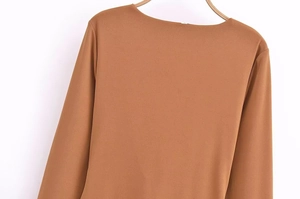 Detail view of the back collar and smooth fabric texture of this elegant brown dress
