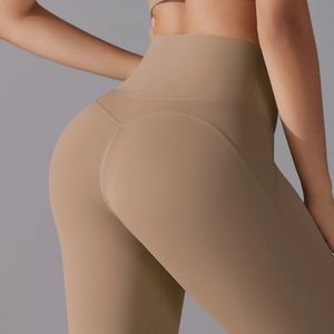 Detail view of khaki high-waisted yoga leggings showing V-shaped back seam and matte fabric
