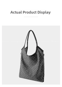 Detail of black tote bag with silver rhinestone grid pattern and leather strap