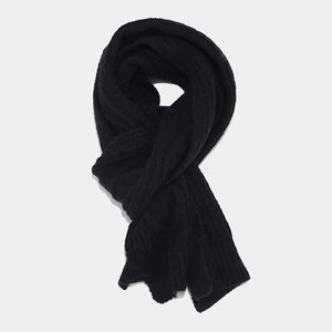 Detailed view of the black cable knit texture on a soft winter warm scarf for women