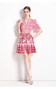 Close-up of V-neck buttoned bodice with retro red porcelain print and puff sleeves