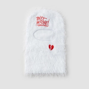 Close-up of white plush ski mask featuring red Trust No One embroidery and broken heart detail