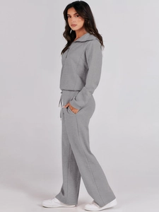 Detail of grey two-piece lounge set with half-zip sweatshirt and wide-leg joggers