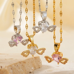 Elegant heart zircon necklace with angel wings in gold and silver plating on stone background