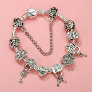 Detail of silver-plated snake chain bracelet with heart charms and crystal beads