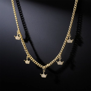 Gold plated necklace featuring five crown pendants with pavé zircons on black background