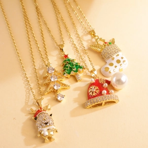 Detail view of five Christmas themed gold necklaces with enamel charms and zircon stones