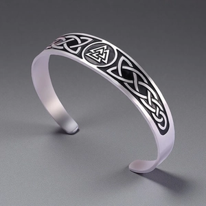 Close-up of vintage Celtic knot and Valknut engraving on silver cuff bracelet