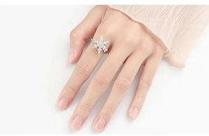 Close-up of rotatable silver snowflake spinner ring with sparkling crystals on hand