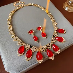 Vintage gold necklace and earring set with red teardrop stones and bow crystals