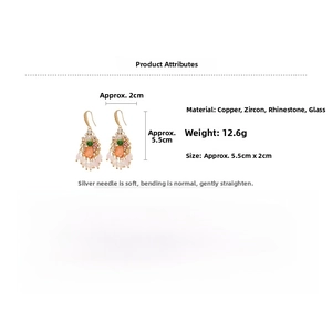 Detail view of crystal water drop earrings showing copper base and zircon stones