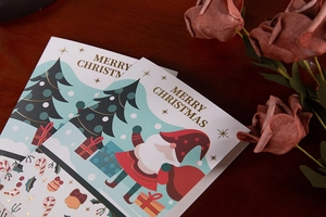 Detail view of premium gold foil Christmas cards with festive tree and Santa illustrations