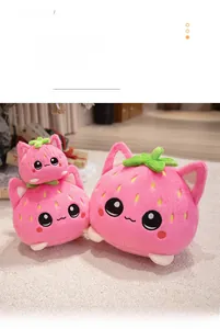 Detailed view of three sizes of pink strawberry cat plush toys on a soft carpet