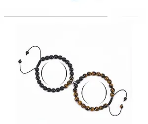 Detail view of 8mm tiger eye and matte black bead bracelets with magnetic closure