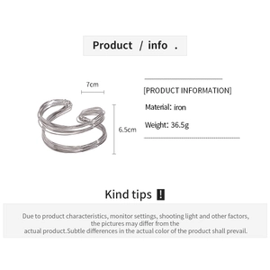 Detailed view of silver twisted geometric bangle with 7cm by 6.5cm dimensions