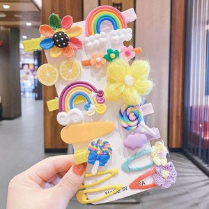 Close-up of colorful cartoon children hair clips including rainbow and flower patterns