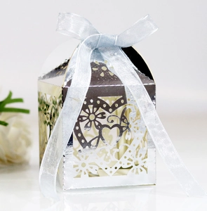 Silver laser-cut heart candy box with light blue ribbon for wedding favors