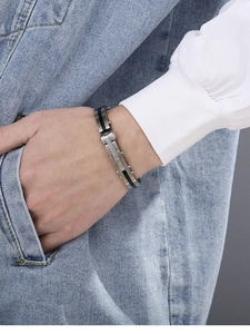 Detail of vintage stainless steel cuff bracelet with black carbon fiber inlay for men