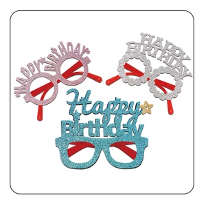 Close-up of three glitter Happy Birthday party glasses in pink, silver, and blue colors