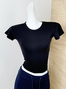 Close-up of black modal knit rib texture on a slim-fit crew neck athletic t-shirt