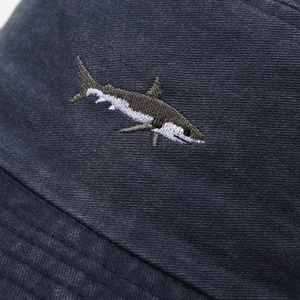 Detailed view of high-quality shark embroidery on navy cotton twill sun hat fabric