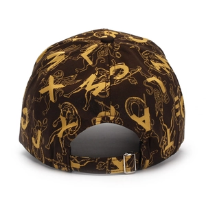 Detail of adjustable silver metal buckle on the back of a patterned brown baseball cap