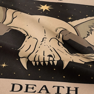 Macro detail of Bohemian tarot tapestry showing woven texture and the Death card skull design
