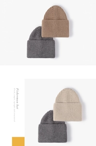 Detail of knitted beanie hats in dark grey, coffee, and beige with vertical ribbed texture
