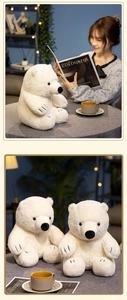 Close-up of cute white plush polar bear dolls showing soft fur and black nose details