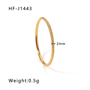 Macro detail of a 2mm wide matte 18K gold plated stainless steel ring weighing 0.5g