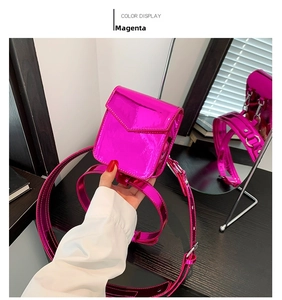 Detail of fuchsia mini square bag with metallic gloss finish and adjustable strap